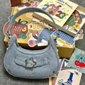 Light blue denim hobo bag with star rivet accents and a Y2K aesthetic design - Denim Blue