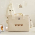 Detailed embroidery of three small bears on a beige canvas mother and baby bag - White