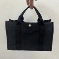 Grand sac à langer en toile noire avec poignées tissées et bouton pression en métal argenté - Noir Pur