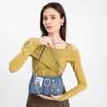 Detail of denim star shoulder bag with silver chain and metal button accents - Blue