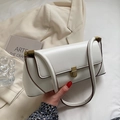 Chic white retro underarm bag with gold clasp and brown edge detail on cream aesthetic background - White
