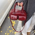 Bolso bowling vintage burdeos en cuero encerado mostrado con modelo en un entorno - Burdeos