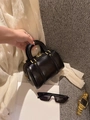 Detailed close-up of glossy black barrel bag with premium gold zipper and metal hardware - Small / Black