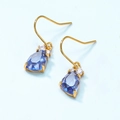 Detail shot of pear-cut blue crystal drop earrings with gold hooks and tiny accents - 925 Silver / Synthetic Blue Crystal