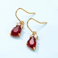 Elegant gold drop earrings with large faceted red pear-shaped crystals and small zircons - Synthetic Garnet