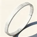 Silver stainless steel evil eye bangle featuring ribbed texture and stud screw details - Steel Color Dense Grooved Nail (47-C-4)