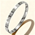 Detailed view of silver stainless steel bangle with engraved Roman numerals and floral pattern - Steel Color Roman Numerals Circle (47-B-1)