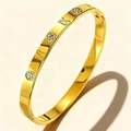 Detail of gold-plated stainless steel bangle with roman numeral engravings and hinge clasp - Gold Roman Numerals Circle (47-B-2)