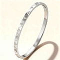 Detailed macro view of silver stainless steel bangle with engraved geometric patterns and stones - Steel Color Geometric Zirconia (52-C-5)