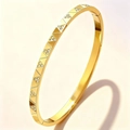 Elegant gold-plated stainless steel bangle featuring geometric triangle patterns and crystals - Gold Geometric Zirconia (52-C-6)