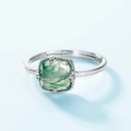 S925 silver open ring with cushion-cut green moss agate stone on a light blue background - Adjustable US 7 / Moss Agate
