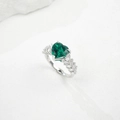 Macro shot of heart-cut emerald ring on white stone, featuring vintage luxury design - HK Size 15# / Lab-Grown Emerald