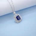 Macro shot of a rectangular blue sapphire pendant with sparkling diamond halo on silver chain - Blue (NL024673-B) / 925 Silver