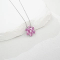 Nahaufnahme einer silbernen Blumenhalskette mit rosa Blütenblättern auf weißem Steinhintergrund - Labor-Rosa-Saphir Anhänger Ohne Kette (NL024670-F) / 925er Silber