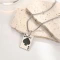 Silver stainless steel Ace of Spades necklace displayed on beige travertine stone - Ace Of Spades Poker Card Style