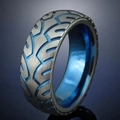 Detailed macro shot of titanium steel ring with blue inner plating and tire tread texture - US 6 / Blue Tire