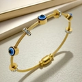 Golden cable twist bracelet with blue evil eye beads and sparkling rhinestone spacers - Gold Evil Eye Style