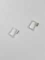 Macro view of textured sterling silver rectangular hoop earrings with black agate insets - Silver