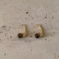 Elegant gold drop earrings with polished brown tiger eye stone beads on stone background - Gold