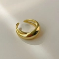Detailed macro view of a minimalist golden wide dome ring with polished surface - Gold