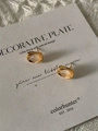 Detail of gold geometric earrings with translucent stone on a minimalist display card - Gold White Chalcedony