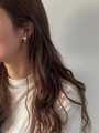 Close-up of S925 sterling silver funnel-shaped stud earring worn on model's ear lobe - Silver