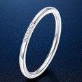 Minimalist silver steel thin ring featuring three small round stones on dark blue background - US 5 / Triple Zirconia Design / Steel