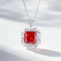 Macro shot of rectangular orange gemstone pendant with diamond halo on silver chain - 925 Silver / Padparadscha Red (With Cross Chain) (XL063)