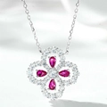 Macro shot of a floral clover pendant with four pink pear-cut gems and white pavé crystals - 925 Silver / Rose Red Zircon