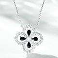 Macro detail of silver four-leaf clover pendant with black stones and micro-pave crystals - 925 Silver / Black Zirconia