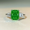 Macro shot of Radiant cut emerald green zircon ring with trapezoid side stones in S925 silver - Emerald Green (CBJZ328)