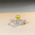 Detailed macro view of pear-cut yellow gemstone crown ring with micro-pave silver setting - US 5 / Yellow Zircon