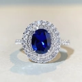 Macro shot of oval blue sapphire halo ring in S925 sterling silver with double diamond pavé - US 5 / Deep Blue Style (CBJZ402)