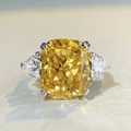 Macro detail of a S925 silver ring featuring a cushion-cut yellow stone and pear side stones - US 5 / Yellow Zirconia