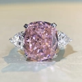 Macro shot of cushion-cut pink gemstone with pear-shaped side diamonds on S925 silver ring - US 5 / Pink Zirconia