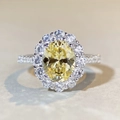 Macro view of a S925 silver ring featuring an oval yellow gemstone with a diamond halo - US 5 / Yellow Rhinestone