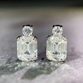 Macro shot of 925 silver stud earrings featuring emerald-cut and round-cut clear gemstones - Stud Earrings Pair (ED088) / 925 Silver / White
