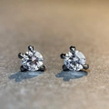 Macro shot of S925 silver dragon claw stud earrings with black metal three-prong settings - D Color White (Black Metal)
