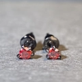 Macro shot of red gemstone earrings featuring black dragon claw settings in S925 silver - 0.1ct Moissanite / Heat Red (Black Metal)