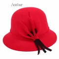 Close-up of crimson wool felt bucket hat featuring decorative leaves and black band - Red