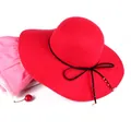 Detail of red wool felt fedora featuring black ribbon bow with pearl and metal bead charms - M (56-58cm) / Red
