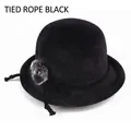 Detailed texture of black knit winter bucket hat with pom-pom and ribbon bow accent - Elastic 57-58cm / Lace-up Black
