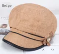 Close-up of beige newsboy hat featuring textured fabric and floral rhinestone detail - 57-59cm / Beige with Border