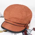 Detail of newsboy cap featuring textured rusty red fabric and leather brim with floral pearl accent - 57-59cm / Cream-Yellow with Piping