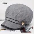 Detail view of grey octagonal newsboy hat with fabric flower and pearl ornament - 57-59cm / Grey with Piping