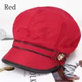 Detail of red newsboy hat with handmade fabric flower and elegant pearl accent - 57-59cm / Red with Piping