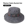 Detail view of light gray bucket hat with colorful ethnic pattern woven ribbon trim - One Size 58cm / Light Grey (Tribal Band)