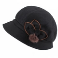 Detail of black wool felt cloche hat featuring a decorative brown flower and fur pompom - Adjustable 57-59cm / Black