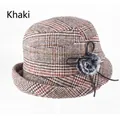 Detail of khaki plaid cloche hat featuring a black bow and soft faux fur pompom decoration - Adjustable 57-58cm / Khaki