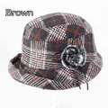 Detail of grey and orange plaid winter bucket hat featuring a faux fur pompom and cord - Adjustable 57-58cm / Brown